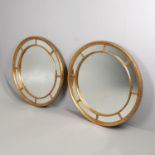 A PAIR OF LARGE CIRCULAR WALL MIRRORS.