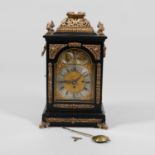 AN EBONISED AND GILT BRACKET CLOCK.