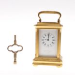 A MINIATURE BRASS CARRIAGE CLOCK.