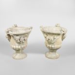 A PAIR OF COMPOSITE STONE GARDEN URNS.