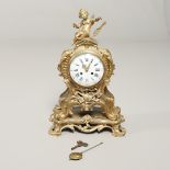 A FRENCH ROCOCO STYLE GILT METAL TABLE CLOCK.