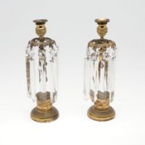 A PAIR OF EMPIRE STYLE GILT BRASS AND LUSTRE CANDLESTICKS.
