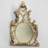 A ROCOCO STYLE GILTWOOD WALL MIRROR.