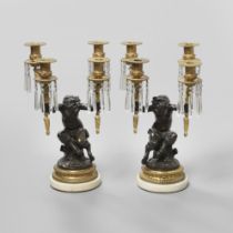 A PAIR OF EMPIRE STYLE GILT AND PATINATED BRONZE CANDELABRA.
