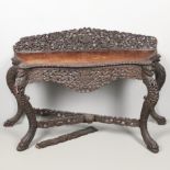 AN EASTERN OR INDIAN CARVED HARDWOOD SIDE TABLE.
