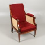 A MAHOGANY AND SATINWOOD BERGERE CHAIR.