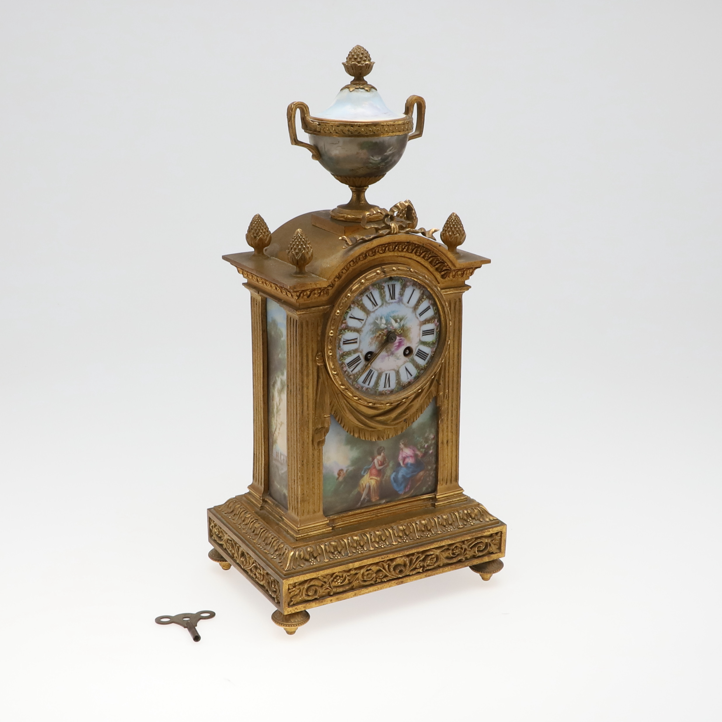 A FRENCH GILT METAL AND PORCELAIN MANTEL CLOCK.