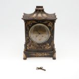 A CHINOISERIE LACQUERED MANTEL CLOCK.