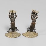 A PAIR OF FIGURAL BRONZE AND GILT METAL PRICKET CANDLESTICKS.