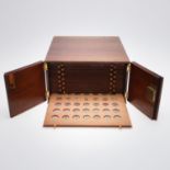 A 20TH CENTURY MAHOGANY COIN CABINET CONTAINING A COLLECTION OF 18TH CENTURY AND LATER COINS.