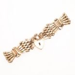 A 9CT GOLD FANCY GATE LINK BRACELET.