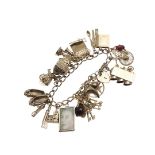 A 9CT GOLD CHARM BRACELET.