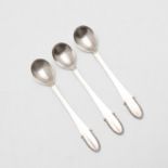 THREE SMALL EARLY 20TH CENTURY DANISH SPOONS, BY GEORG JENSEN.