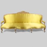 A 19TH CENTURY FRENCH GILTWOOD SALON SETTEE.