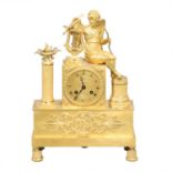 A FRENCH EMPIRE STYLE GILT MANTEL CLOCK.