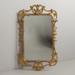 AN EARLY 20TH CENTURY GILTWOOD LOOKING GLASS.