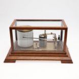 AN OAK CASED BAROGRAPH BY HARROD'S OF LONDON.