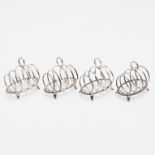 AN EARLY 20TH CENTURY CASED SET OF FOUR SMALL TOAST RACKS.