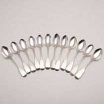 A SET OF ELEVEN VICTORIAN, WEST-COUNTRY PROVINCIAL FIDDLE PATTERN DESSERT SPOONS.