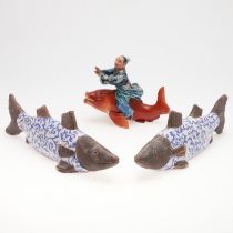 JAPANESE PORCELAIN FIGURE OF A SAGE RIDING A CARP, & PAIR OF POTTERY FISH.