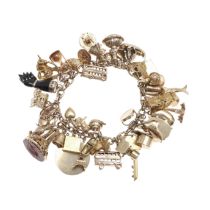 A 9CT GOLD CHARM BRACELET.