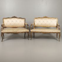 A NEAR PAIR OF FRENCH GILT FRAMED SETTEES.