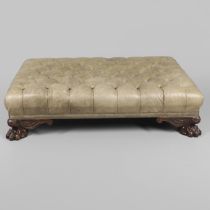 A WILLIAM IV STYLE MAHOGANY AND LEATHER OTTOMAN.