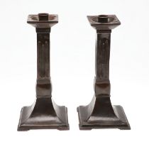 A PAIR OF ARCHITECTURAL COPPER CANDLESTICKS.