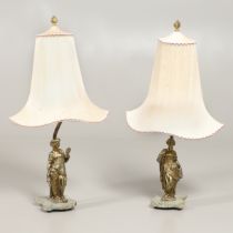 A PAIR OF GILT METAL FIGURAL TABLE LAMPS AND SHADES.