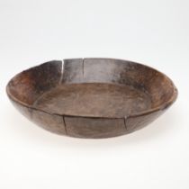 A LARGE RUSTIC CARVED DAIRY BOWL.
