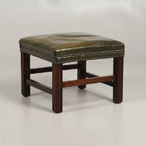 A GREEN LEATHER FOOT STOOL.