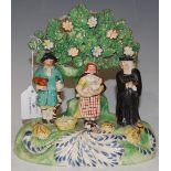 A 19TH CENTURY STAFFORDSHIRE PEARL WARE FIGURE GROUP 'THE TITHE PIG'