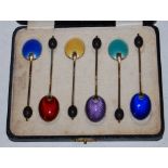 A CASED SET OF SIX BIRMINGHAM SILVER GILT AND ENAMEL COFFEE SPOONS WITH BEAN-SHAPED TERMINALS