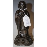AN ANTIQUE CHINESE BRONZE FIGURE OF A STANDING MONK, PROBABLY EARLY QING DYNASTY, 19CM HIGH