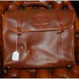 A LEATHERETTE BAG CONTAINING FOUR VINTAGE BOWLING BALLS