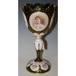 A LATE 19TH CENTURY BOHEMIAN GREEN GLASS GOBLET WITH OPAQUE WHITE GLASS OVERLAY, DECORATED WITH