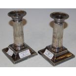 A PAIR OF ELECTROPLATED CANDLESTICKS, FLUTED COLUMN DETAIL AND DETACHABLE DRIP PANS, 13CM HIGH
