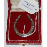 A SILVER MODEL OF A HORSESHOE IN ORIGINAL FITTED CASE