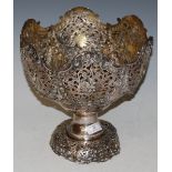 A LARGE WHITE METAL PEDESTAL BOWL WITH PIERCED FOLIATE SCROLL AND EMBOSSED BIRD DETAIL,