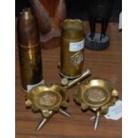 A GROUP OF TRENCH ART TO INCLUDE TWO ASHTRAYS, SHELL CASE SUPPORTED ON THREE BULLET CASE SUPPORTS