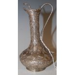 AN INDIAN SILVER JUG, THE HANDLE AND FINIAL FORMED AS A COBRA SNAKE, THE JUG WITH EMBOSSED FLOWER