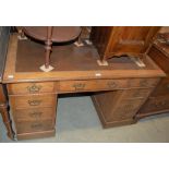 A VICTORIAN OAK PEDESTAL DESK, RECTANGULAR TOP WITH BROWN SKIVER OVER THREE FRIEZE DRAWERS ON