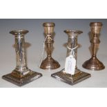A PAIR OF LONDON SILVER CANDLESTICKS WITH EMBOSSED RIBBON-TIE AND SWAG DETAIL ON SQUARE BASES,