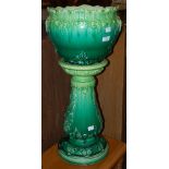 A GREEN CERAMIC JARDINIERE ON STAND WITH LEAF MOULDED DETAILS