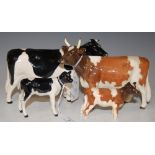 A GROUP OF FOUR BESWICK COWS