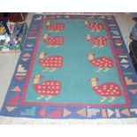 A KILIM TYPE FLATWEAVE RUG, THE GREEN GROUND DECORATED WITH EIGHT STYLISED BIRDS WITHIN A BLUE