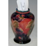 A SMALL MOORCROFT VASE DECORATED WITH POMEGRANATES ON A GREEN-BLUE GROUND, IMPRESSED MARKS AND GREEN