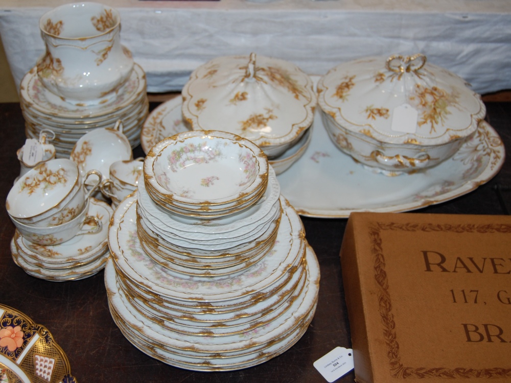 AN EARLY 20TH CENTURY LIMOGES PART TEA AND DINNER SET, DECORATED WITH SCATTERED FOLIATE SPRAYS