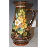 A DOULTON POTTERY JUG DECORATED WITH DAFFODILS, SIGNED MMC FOR MARGARET M. CHALLIS