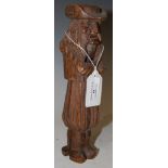 A VINTAGE CARVED WOOD NUT CRACKER IN THE FORM OF A STANDING GENTLEMAN WEARING A HAT WITH ARMS